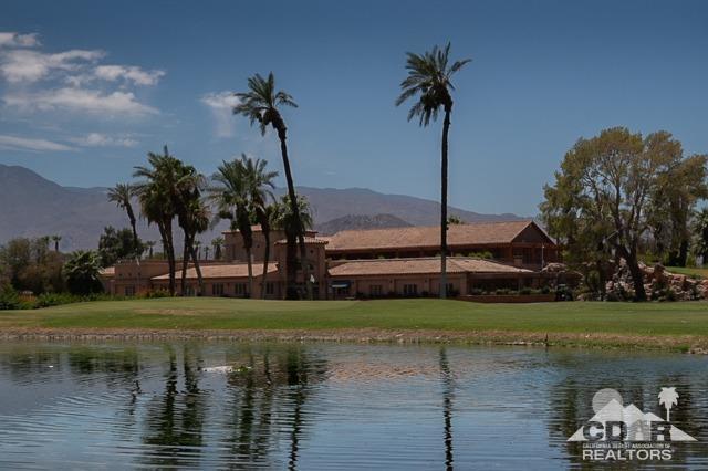 82320 Lancaster Way Indio, CA 92201 - Photo 25 of 27 a view of a lake with a palm tree next to a yard
