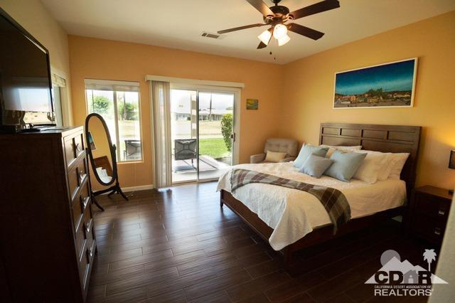 82320 Lancaster Way Indio, CA 92201 - Photo 9 of 27 a spacious bedroom with a bed and glass wall