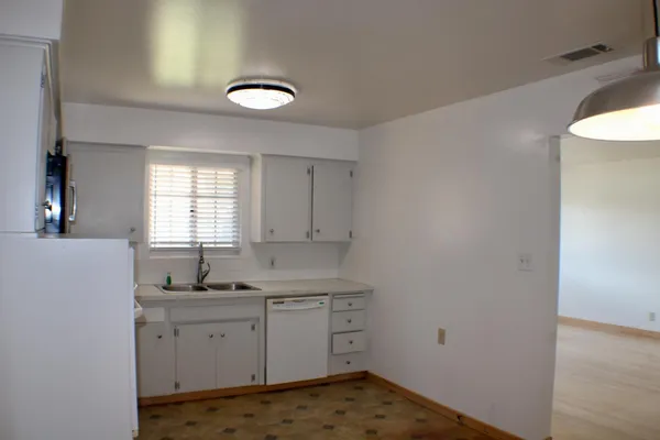 a kitchen with sink cabinets and window