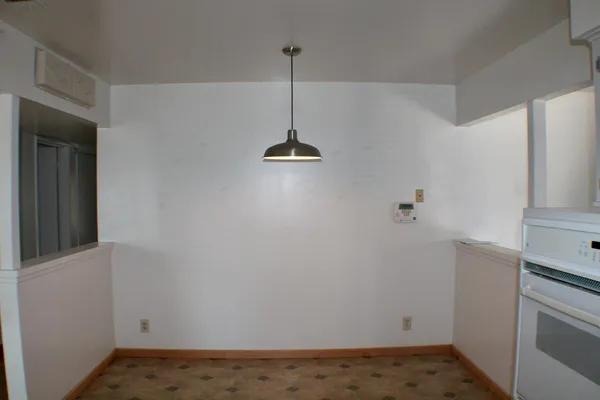 a view of a room with a sink dryer and cabinets