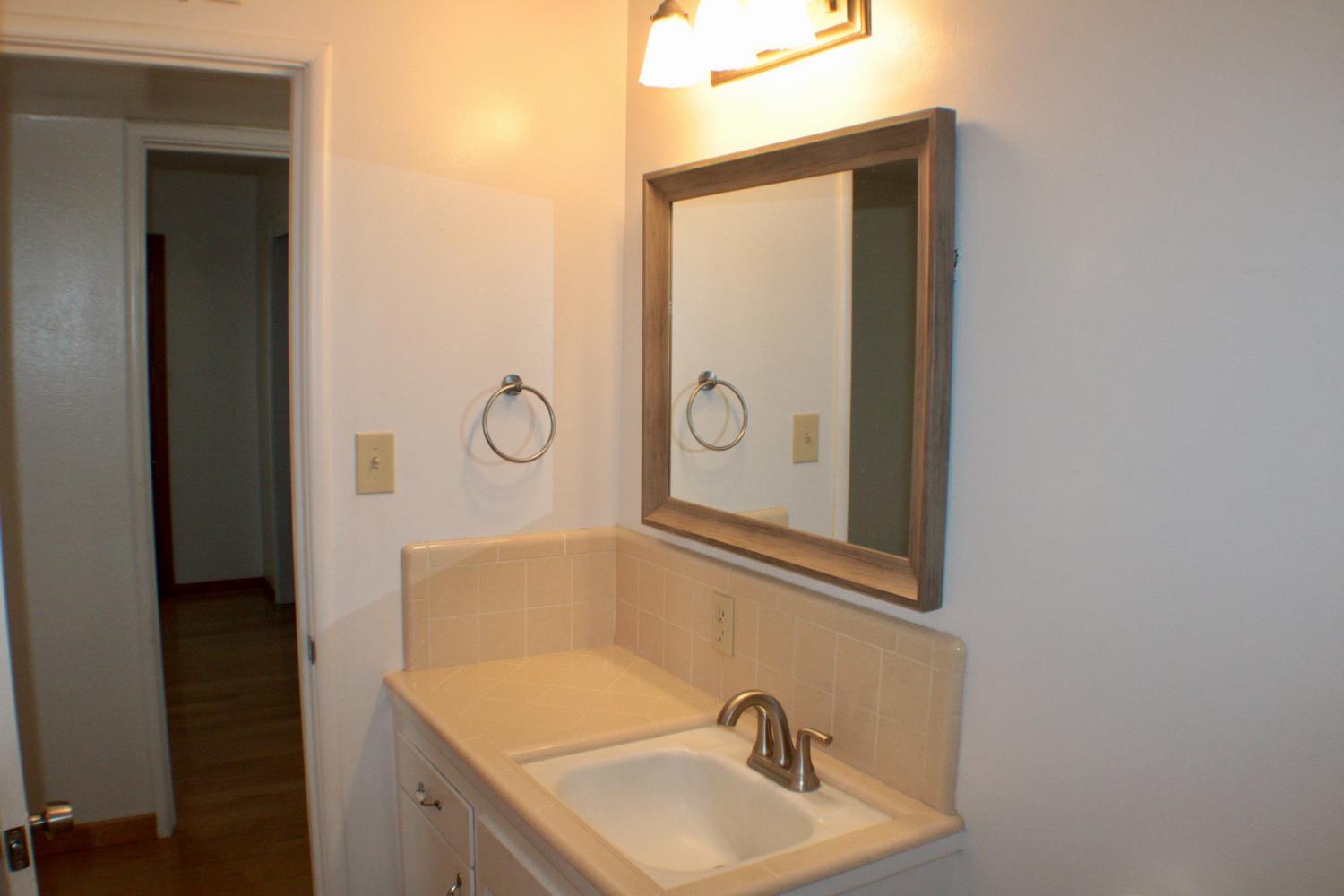 881 West Rialto Avenue Clovis, CA 93612 - Photo 24 of 25 a bathroom with a sink and a mirror