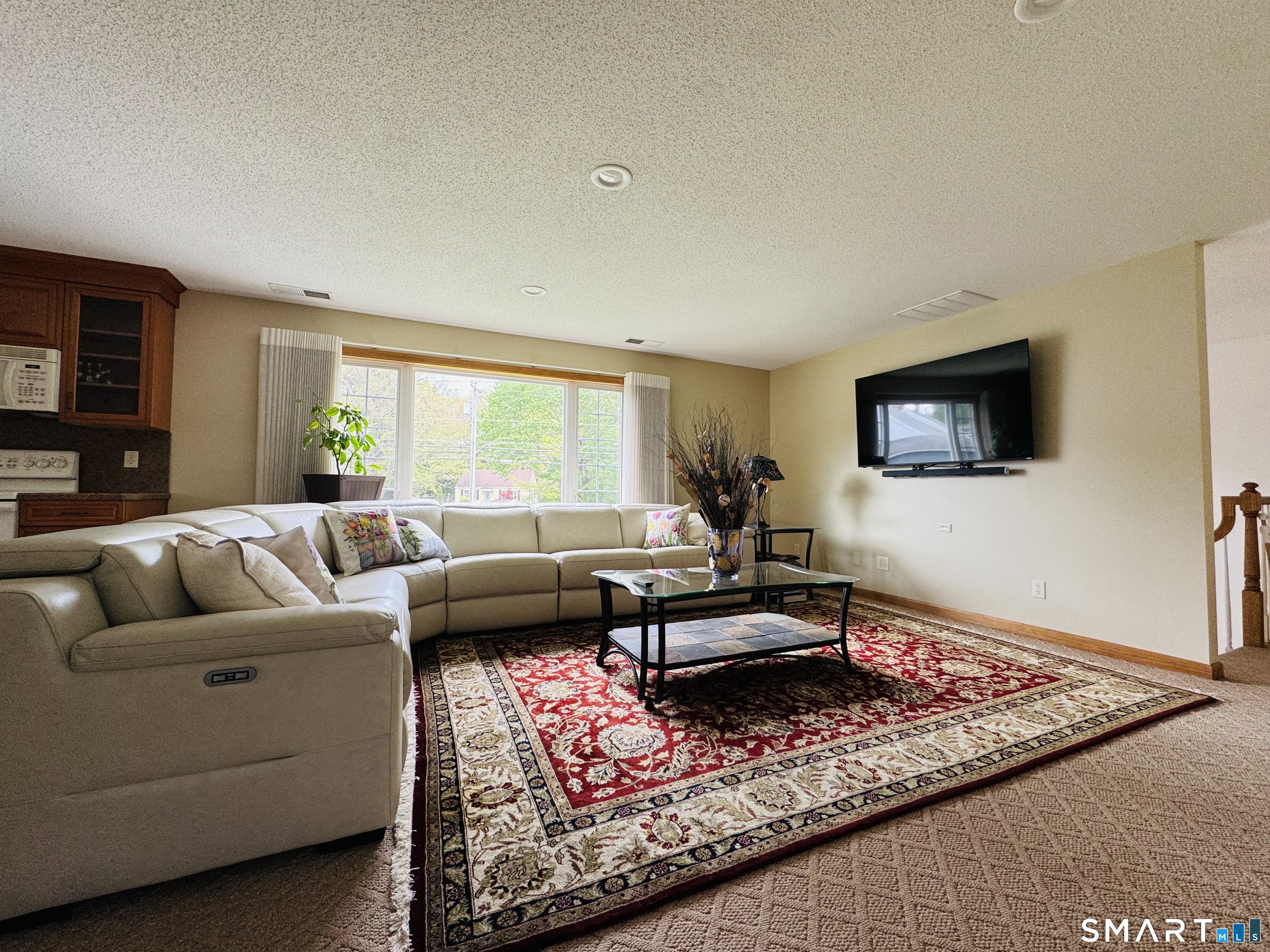 1514 Woodtick Road Wolcott, CT 06716 - Photo 21 of 23 a living room with furniture and a flat screen tv