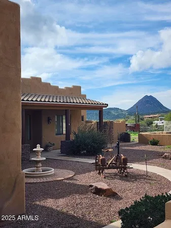 a view of a patio with table and chairs under an umbrella