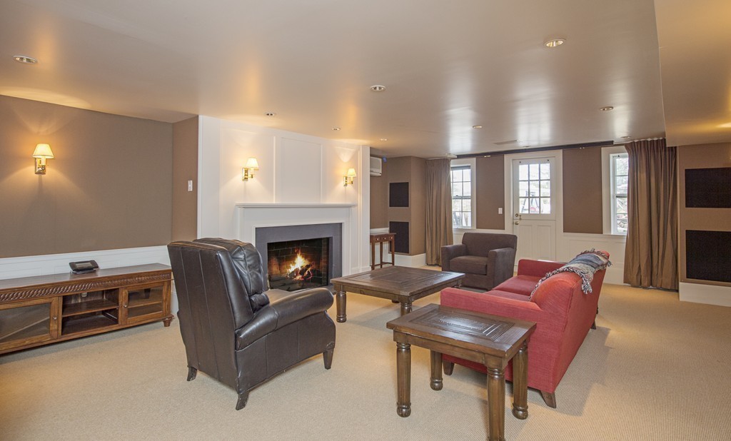 90 Meadowbrook Road Weston, MA 02493 - Photo 15 of 30 a living room with furniture a flat screen tv and a fireplace