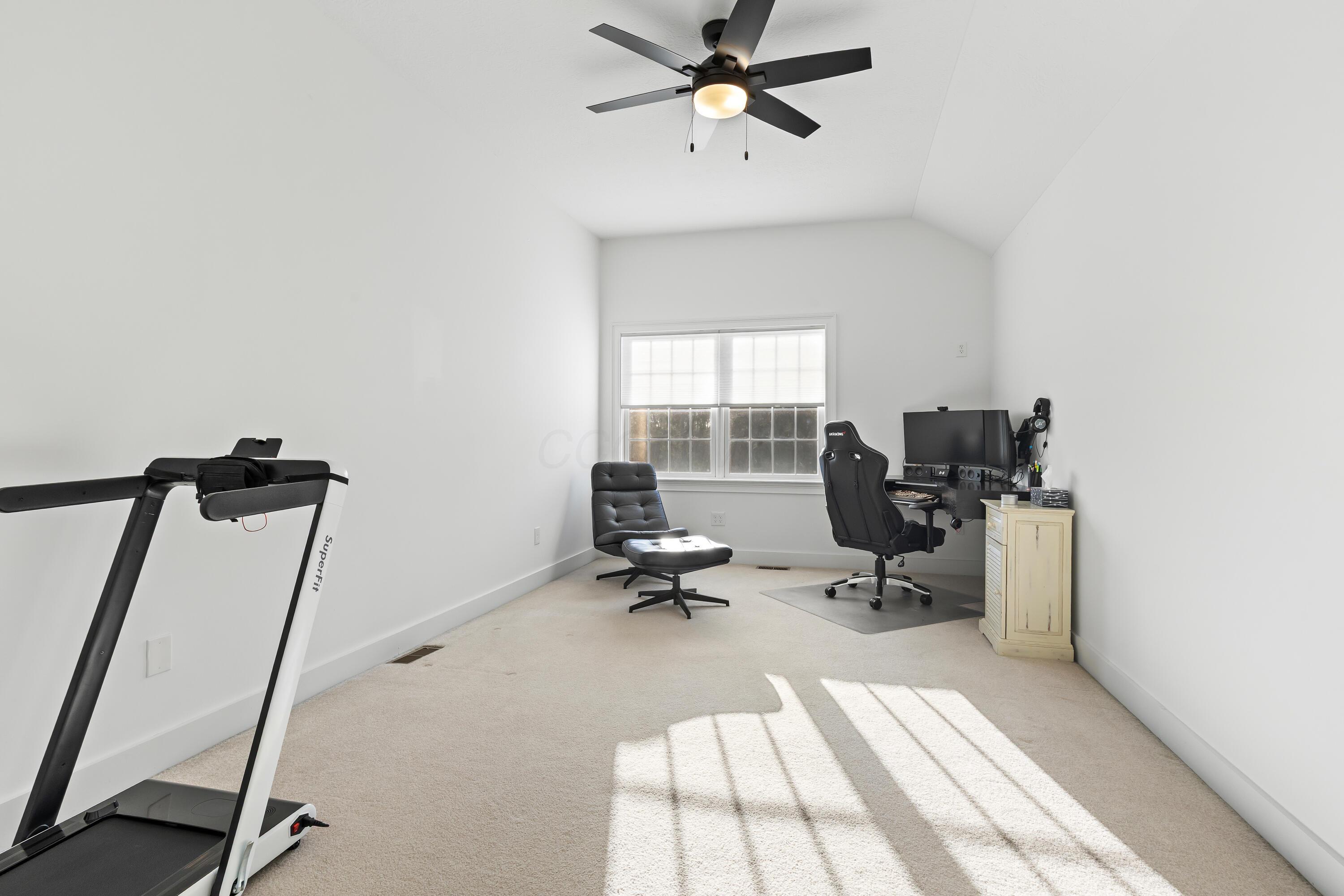 1364 Dale Ford Road Delaware, OH 43015 - Photo 70 of 112 • Light sand carpet • White painted walls • Lighted ceiling fan • Desk remains • Shades remain