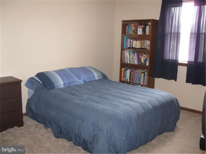2902 Daniel Drive Sinking Spring, PA 19608 - Photo 15 of 24 a bed sitting in a bedroom next to a large window