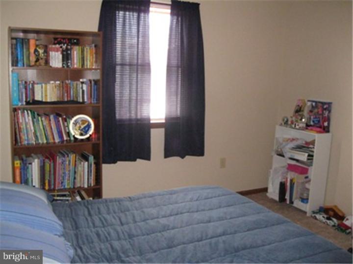 2902 Daniel Drive Sinking Spring, PA 19608 - Photo 16 of 24 a bedroom with furniture and a book shelf