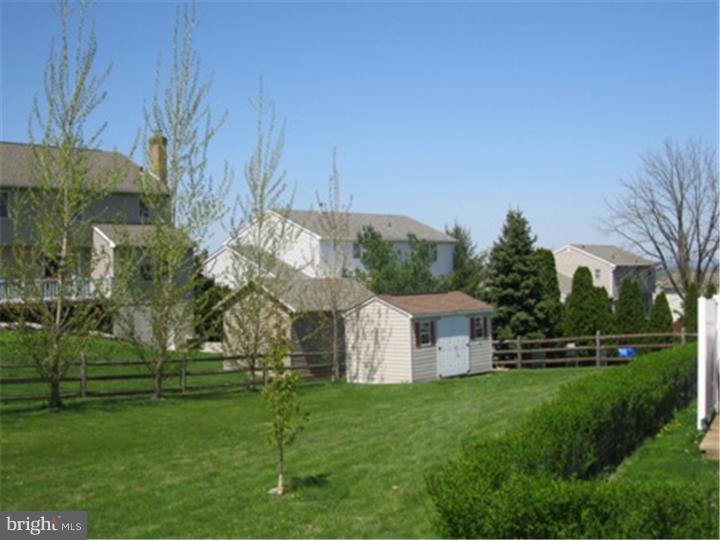 2902 Daniel Drive Sinking Spring, PA 19608 - Photo 24 of 24 a view of a white house with a big yard and potted plants and large trees