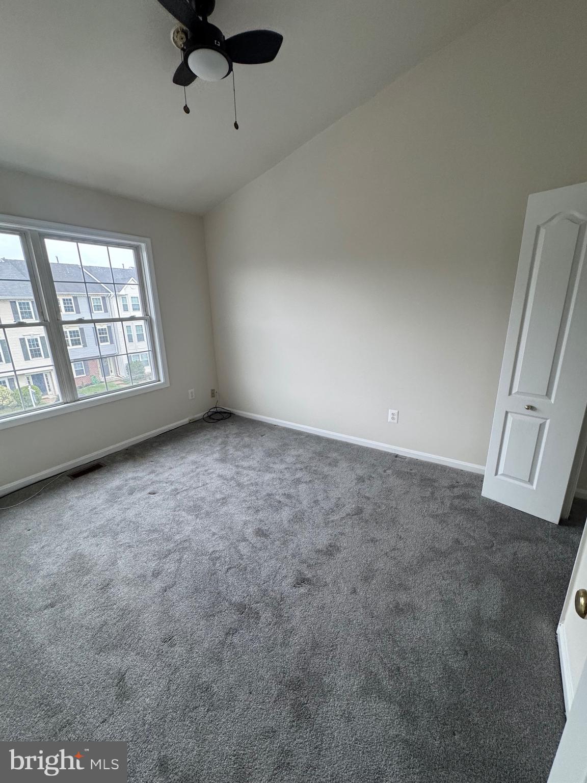7705 Periwinkle Way, Unit 71 Severn, MD 21144 - Photo 24 of 28 an empty room with windows and ceiling fan
