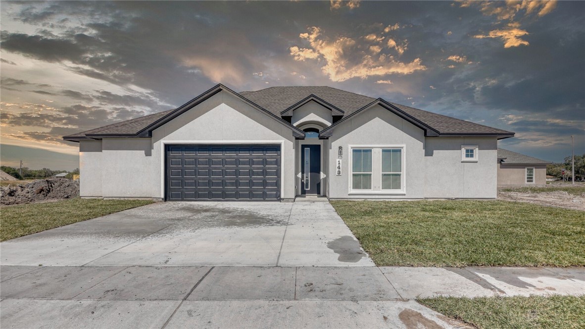 143 Amethyst Street Portland, TX 78374 - Photo 1 of 26 a front view of a house with a yard and garage