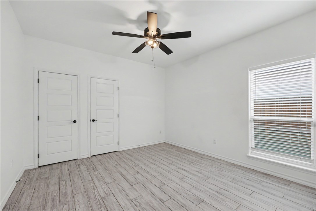 143 Amethyst Street Portland, TX 78374 - Photo 17 of 26 a view of a room with wooden floor and ceiling fan