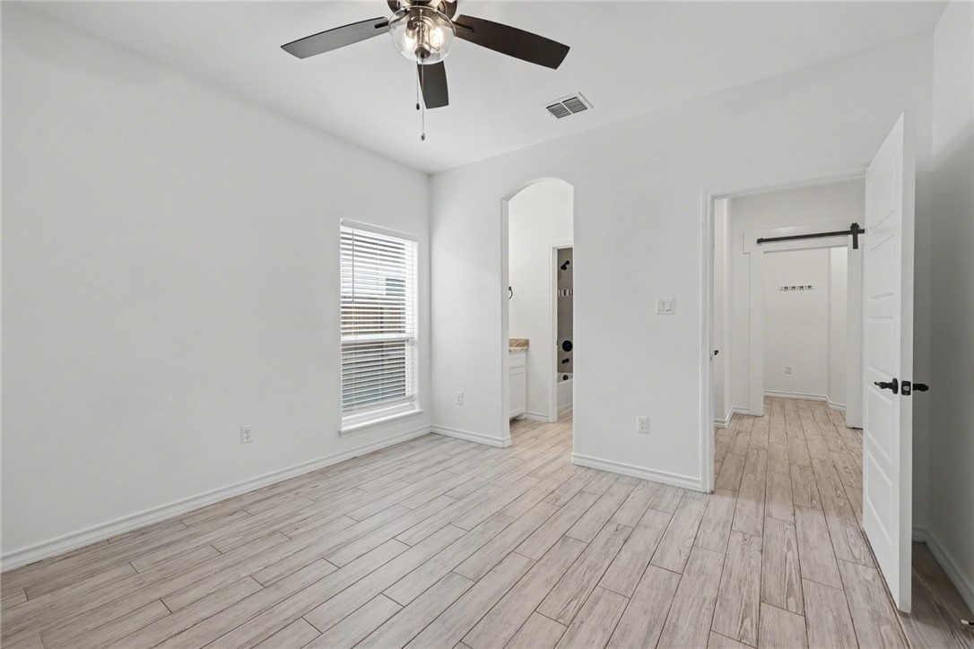 143 Amethyst Street Portland, TX 78374 - Photo 18 of 26 wooden floor in an empty room with a window