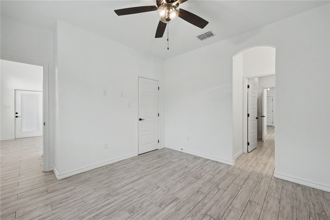 143 Amethyst Street Portland, TX 78374 - Photo 22 of 26 wooden floor in an empty room with a window