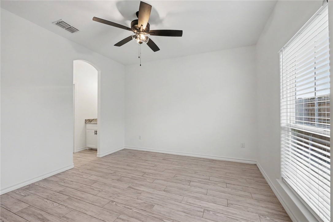 143 Amethyst Street Portland, TX 78374 - Photo 23 of 26 wooden floor in an empty room with a window