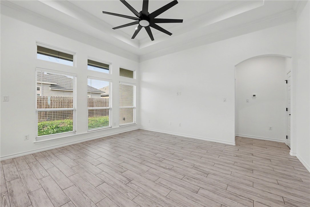 143 Amethyst Street Portland, TX 78374 - Photo 6 of 26 wooden floor in an empty room with a window