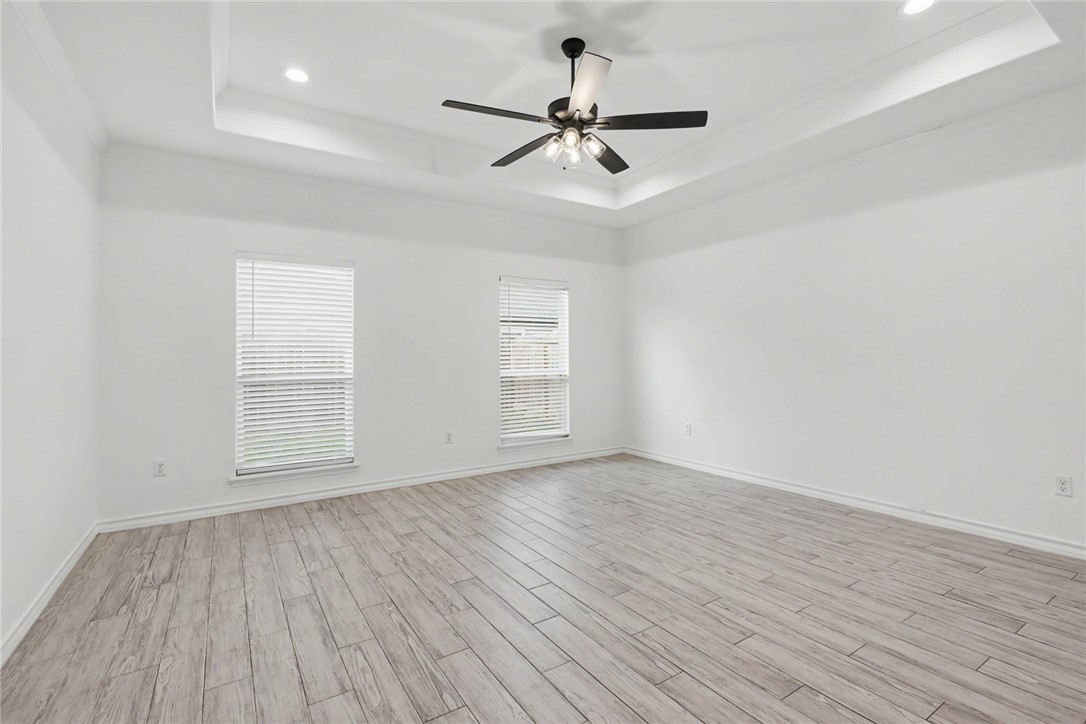 143 Amethyst Street Portland, TX 78374 - Photo 9 of 26 a view of an empty room with wooden floor and a window