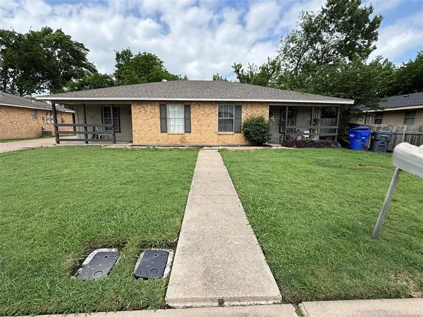 a front view of house with a garden and patio