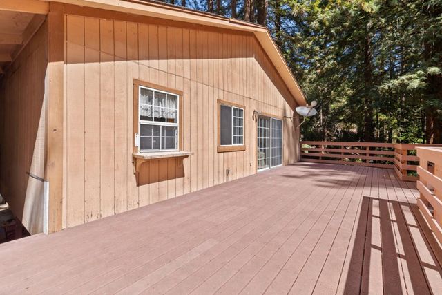 a view of backyard with deck and wooden floor
