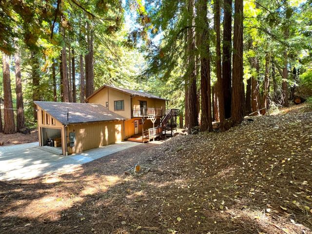 a view of a house with backyard and sitting area