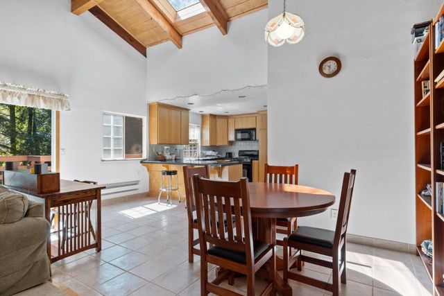 a view of a dining room with furniture and a chandelier