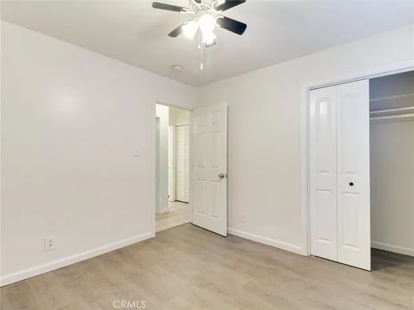 an empty room with fan and entrance