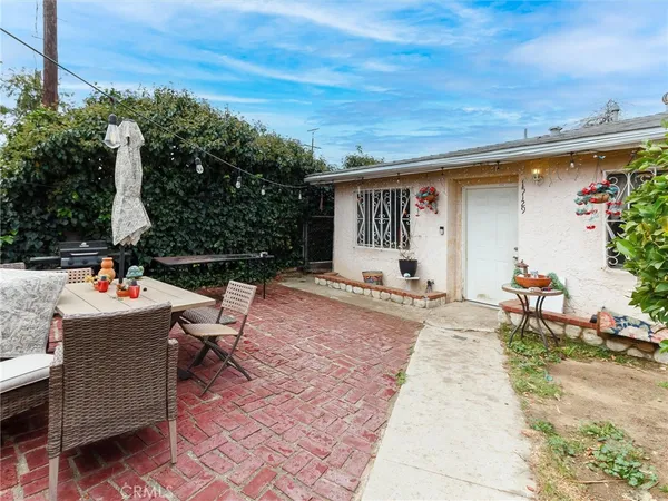 a view of a backyard with sitting area and furniture