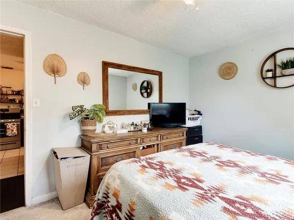 a bedroom with a bed and a television