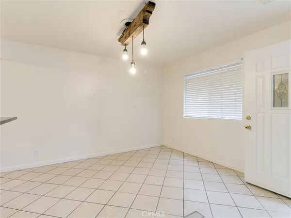 a view of an empty room and a window