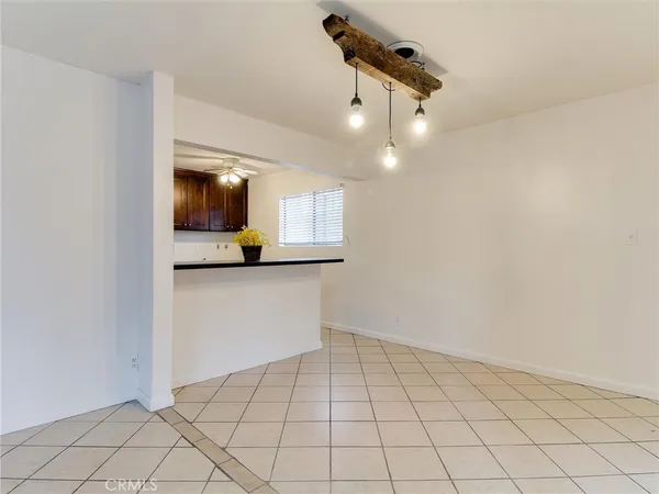 a view of a livingroom with an empty space and a ceiling fan