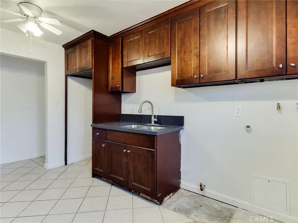 a kitchen with a sink cabinets and appliances