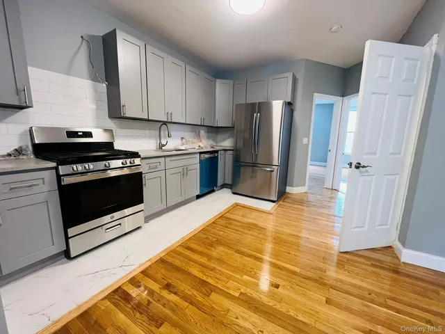 a bathroom with a shower sink vanity and toilet