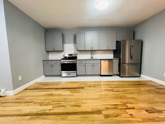 a kitchen with stainless steel appliances granite countertop a refrigerator sink and stove