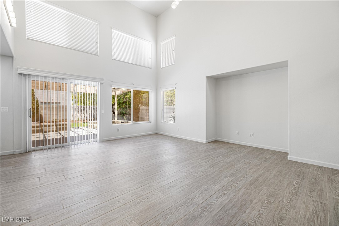 10133 Rice Paper Street Las Vegas, NV 89183 - Photo 11 of 36 Great Room with new TILE wood finished floors and a towering high ceiling