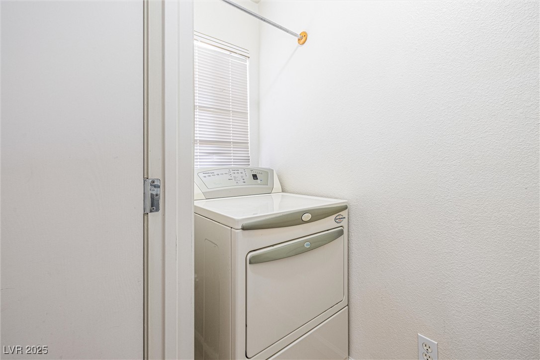 10133 Rice Paper Street Las Vegas, NV 89183 - Photo 31 of 36 Laundry room featuring washer / clothes dryer and a textured wall