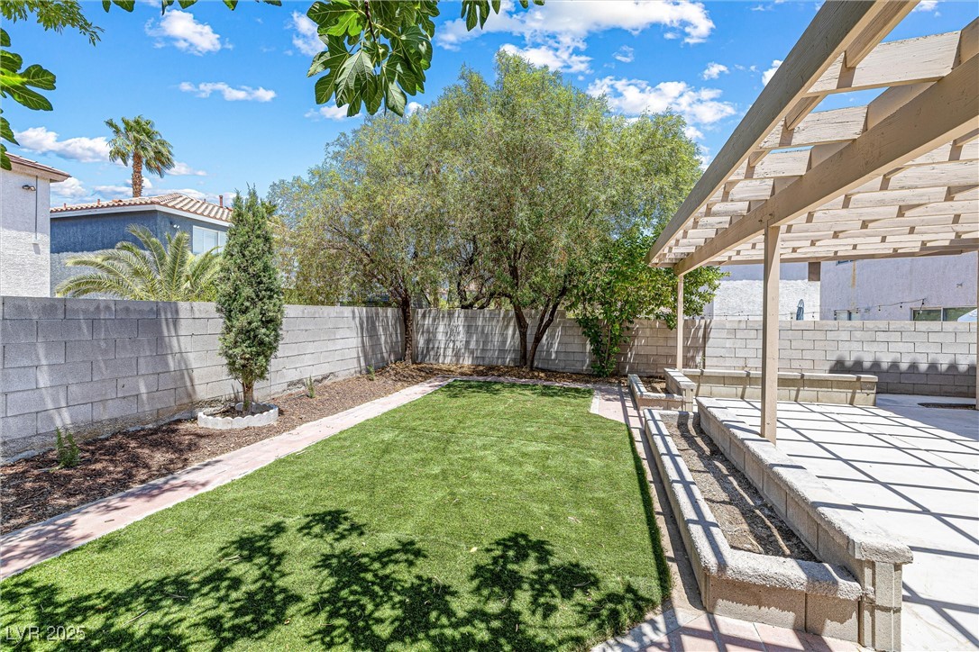 10133 Rice Paper Street Las Vegas, NV 89183 - Photo 36 of 36 Fenced backyard featuring a patio and a pergola