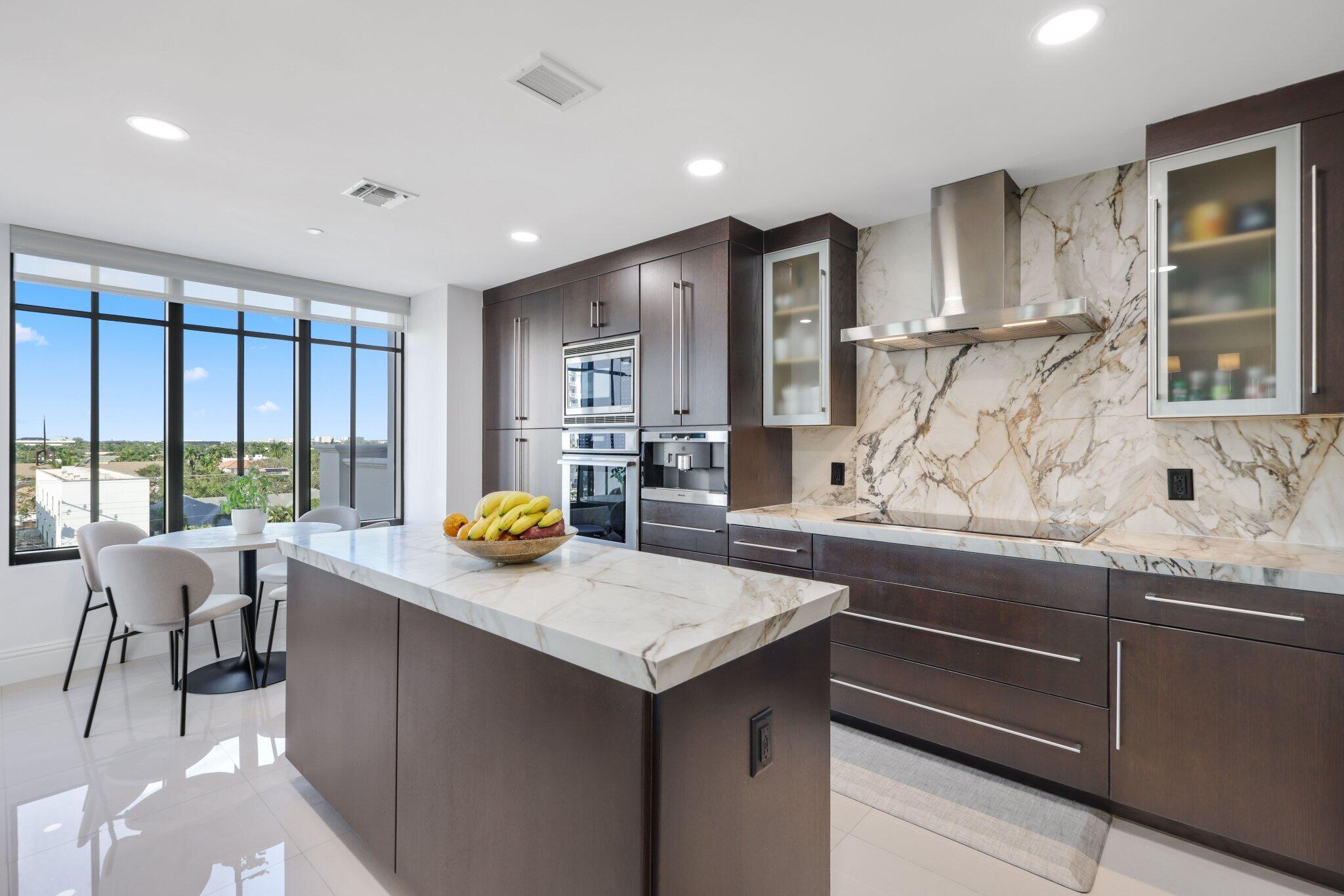 200 East Palmetto Park Road, Unit 505 Boca Raton, FL 33432 - Photo 12 of 71 a kitchen with stainless steel appliances granite countertop sink stove and wooden cabinets