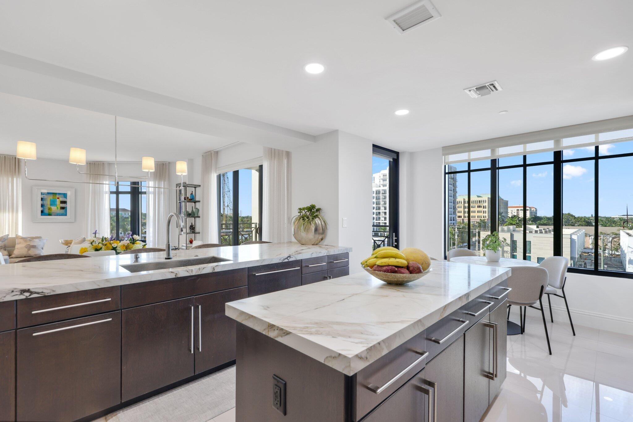 200 East Palmetto Park Road, Unit 505 Boca Raton, FL 33432 - Photo 14 of 71 a kitchen with a sink a counter and chairs