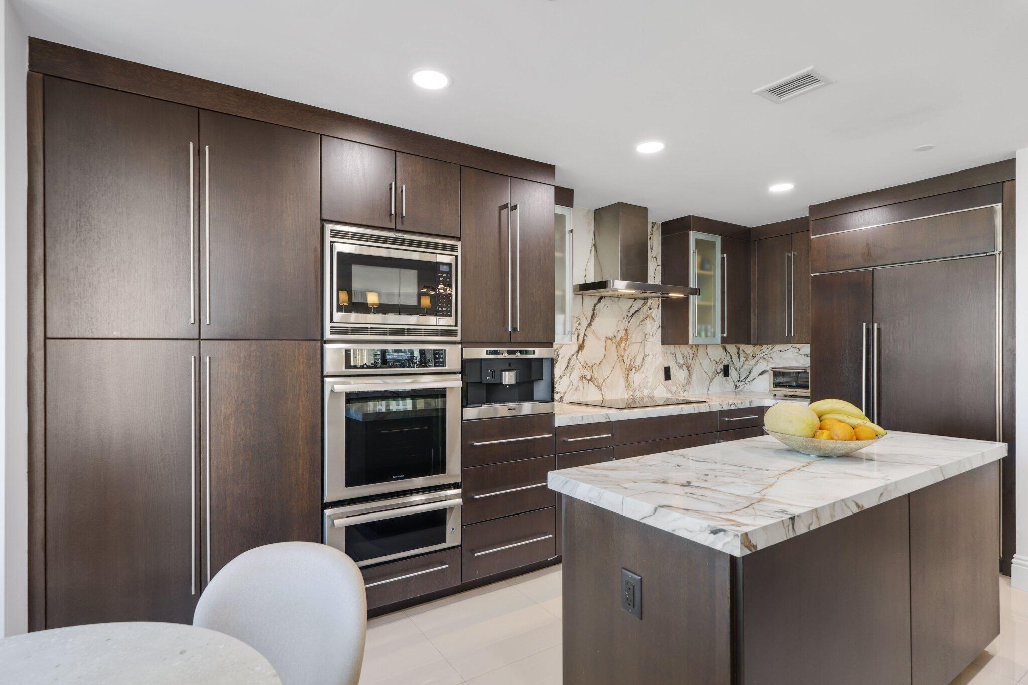 200 East Palmetto Park Road, Unit 505 Boca Raton, FL 33432 - Photo 16 of 71 a kitchen with a refrigerator and a stove top oven