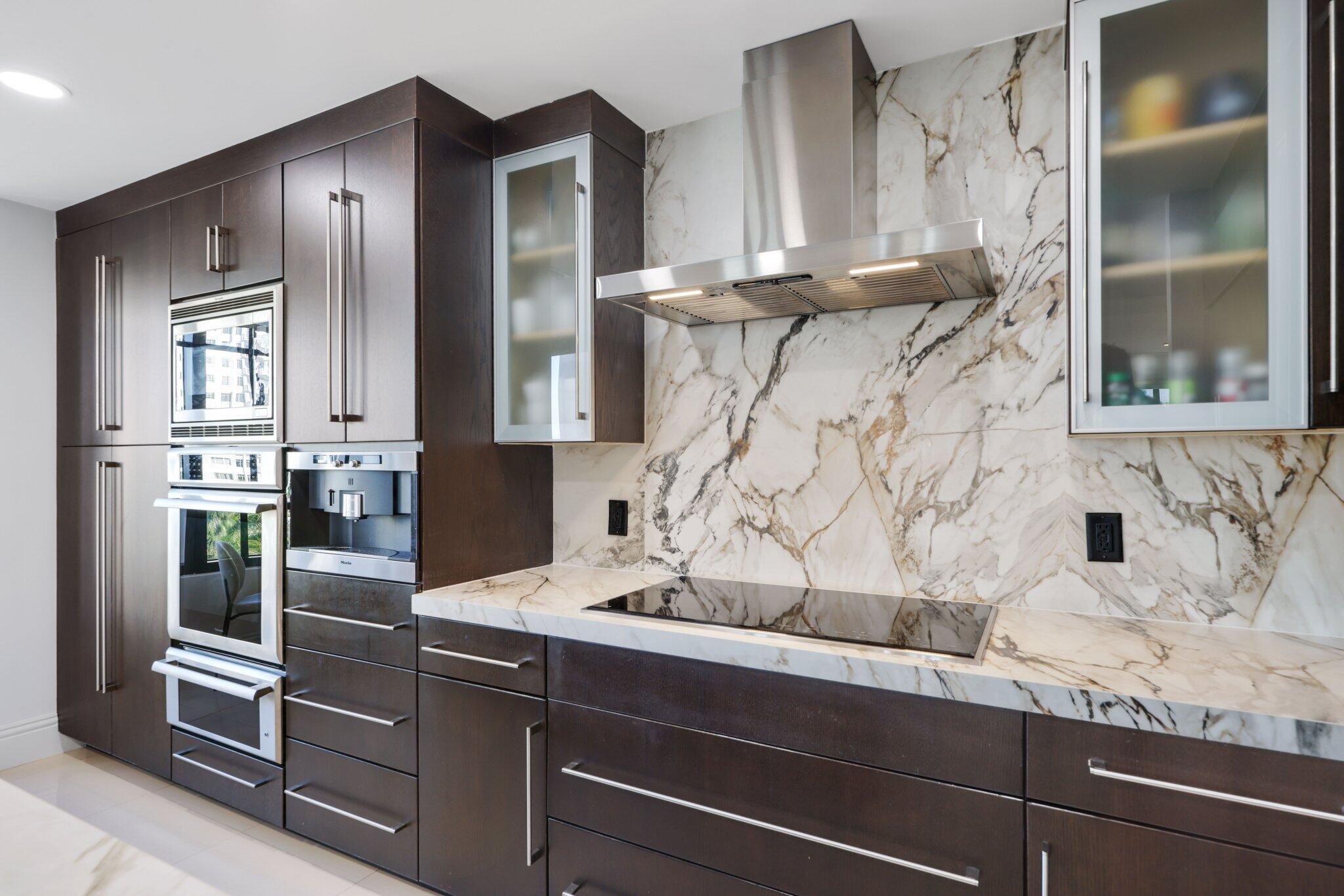 200 East Palmetto Park Road, Unit 505 Boca Raton, FL 33432 - Photo 17 of 71 a kitchen with stainless steel appliances kitchen island granite countertop a refrigerator and a sink