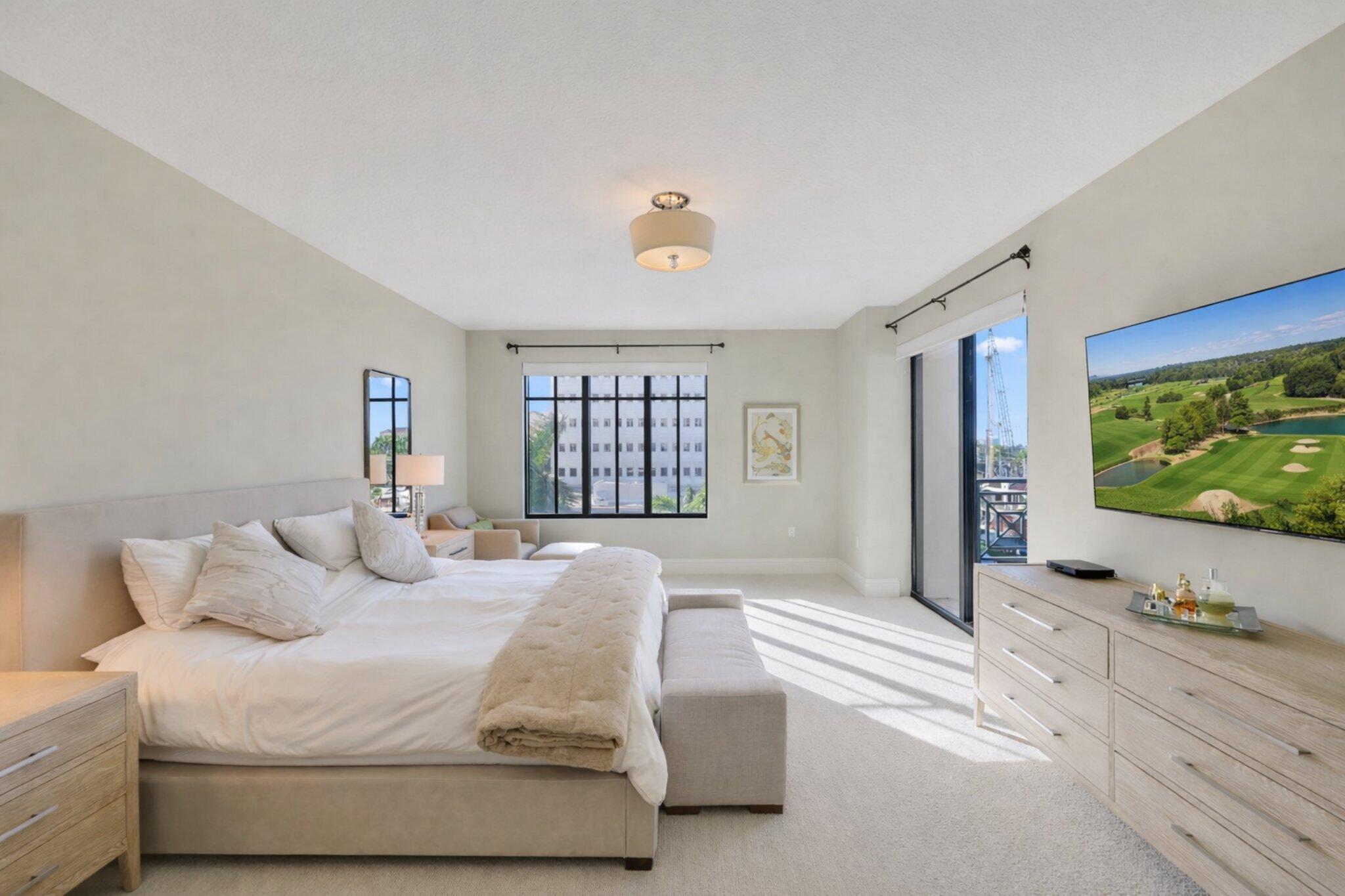 200 East Palmetto Park Road, Unit 505 Boca Raton, FL 33432 - Photo 25 of 71 a bedroom with a bed and a flat screen tv