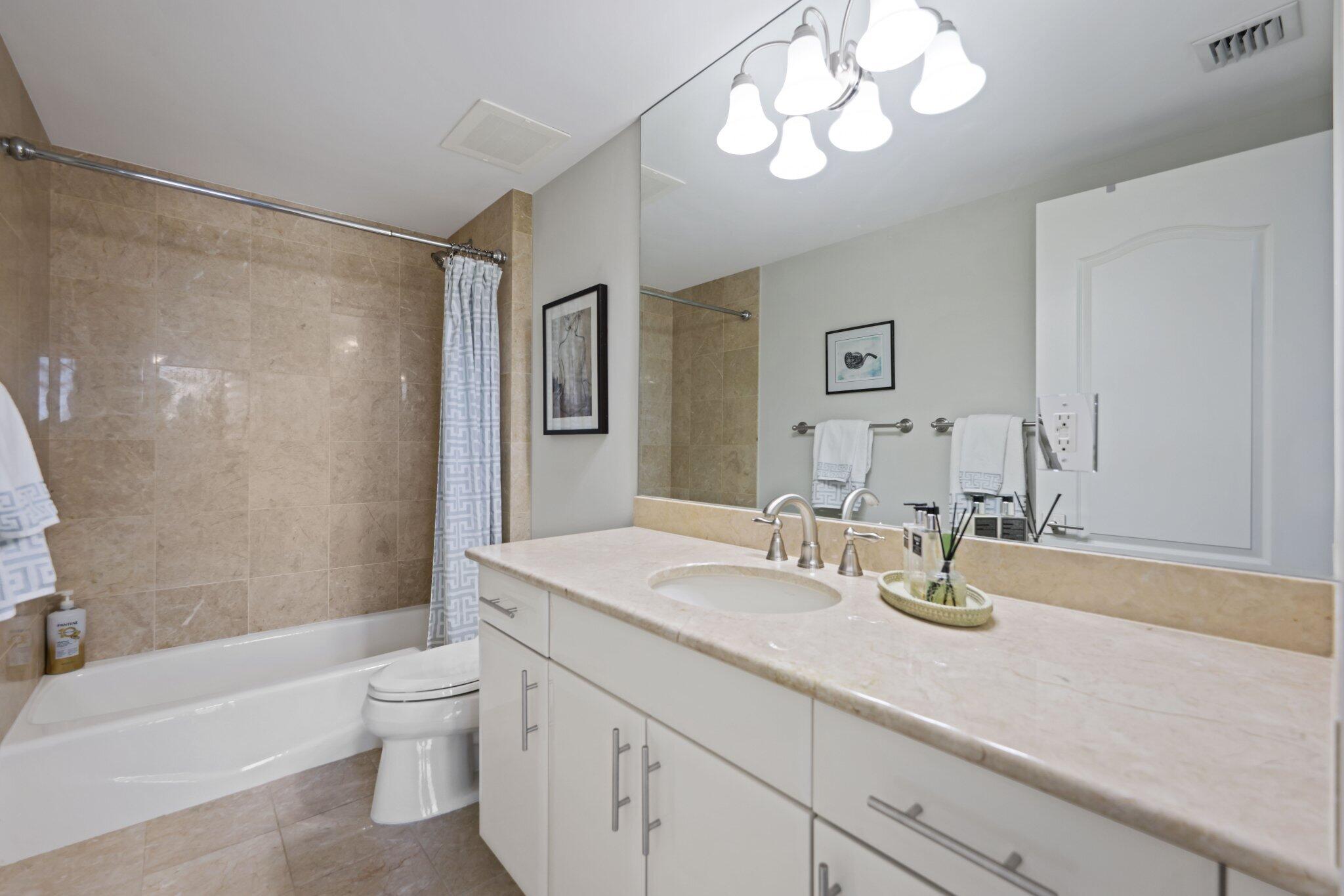 200 East Palmetto Park Road, Unit 505 Boca Raton, FL 33432 - Photo 37 of 71 a bathroom with a sink a toilet and a bathtub