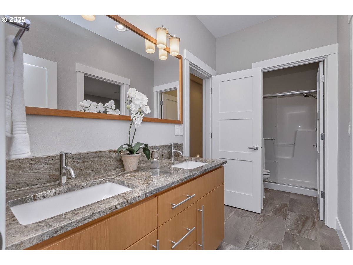32047 Northeast Corral Creek Road Newberg, OR 97132 - Photo 29 of 40 a bathroom with double sink and a mirror