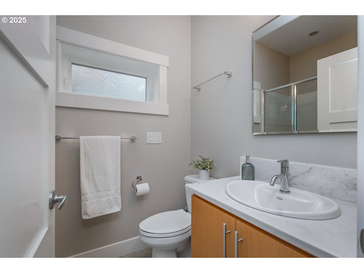 32047 Northeast Corral Creek Road Newberg, OR 97132 - Photo 31 of 40 a bathroom with a granite countertop sink toilet and mirror
