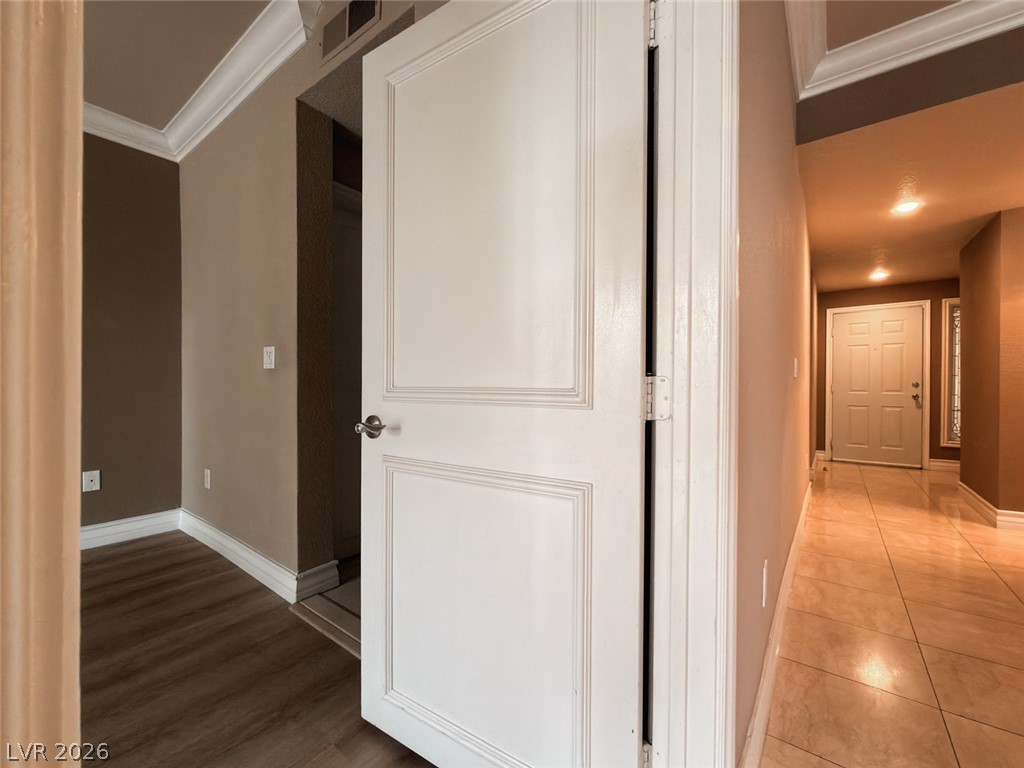 210 East Flamingo Road, Unit 112 Las Vegas, NV 89169 - Photo 12 of 59 An inviting entrance foyer transitions smoothly into the home with detailed crown molding overhead.