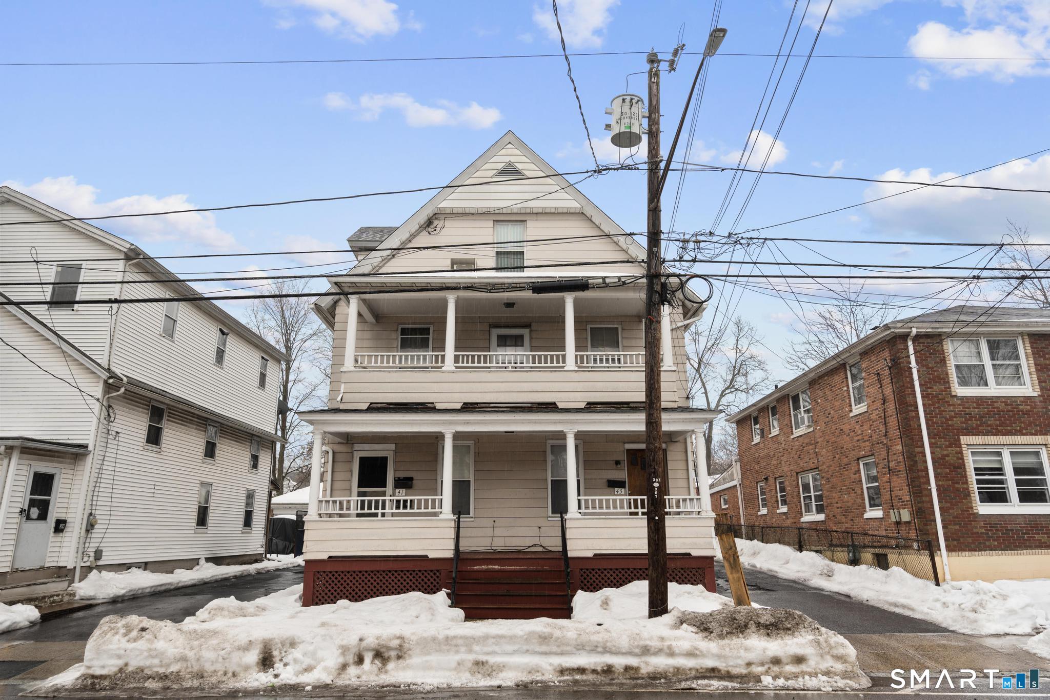 a front view of a house with large windows