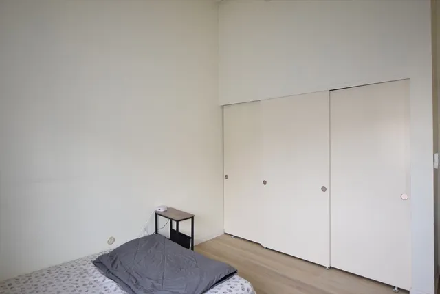a room with a bench and wooden floor
