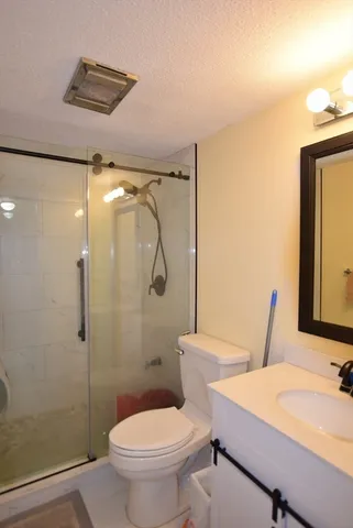 a bathroom with a toilet sink and shower