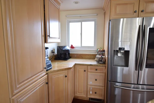 a kitchen with stainless steel appliances a refrigerator sink and cabinets