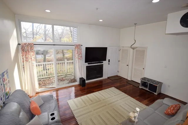 a bedroom with a bed and glass door