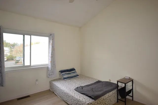 a bedroom with a bed and a window